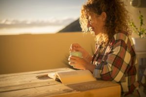 woman with tea at sunset mortgage after separation